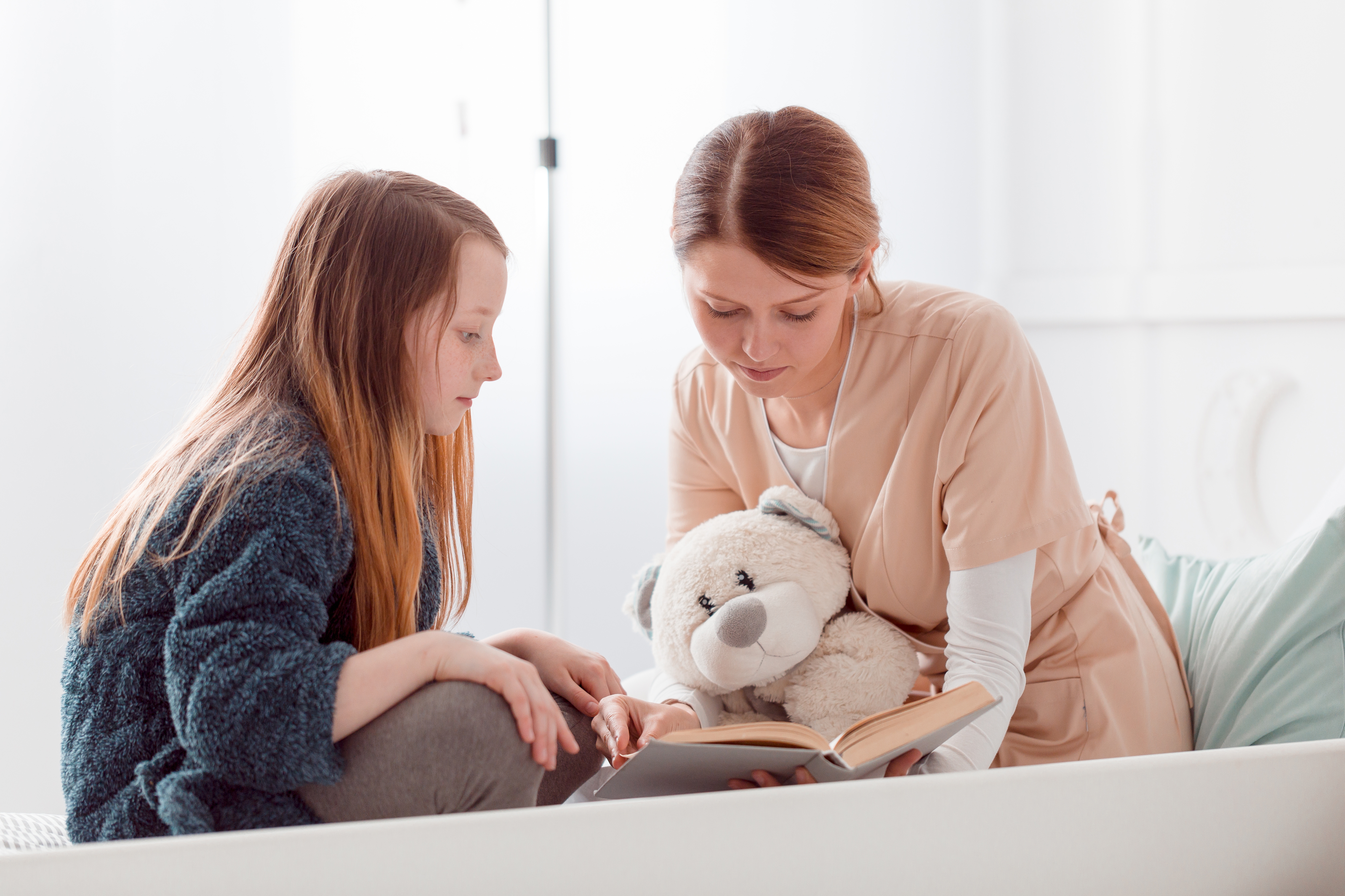 Nurse reading with a girl